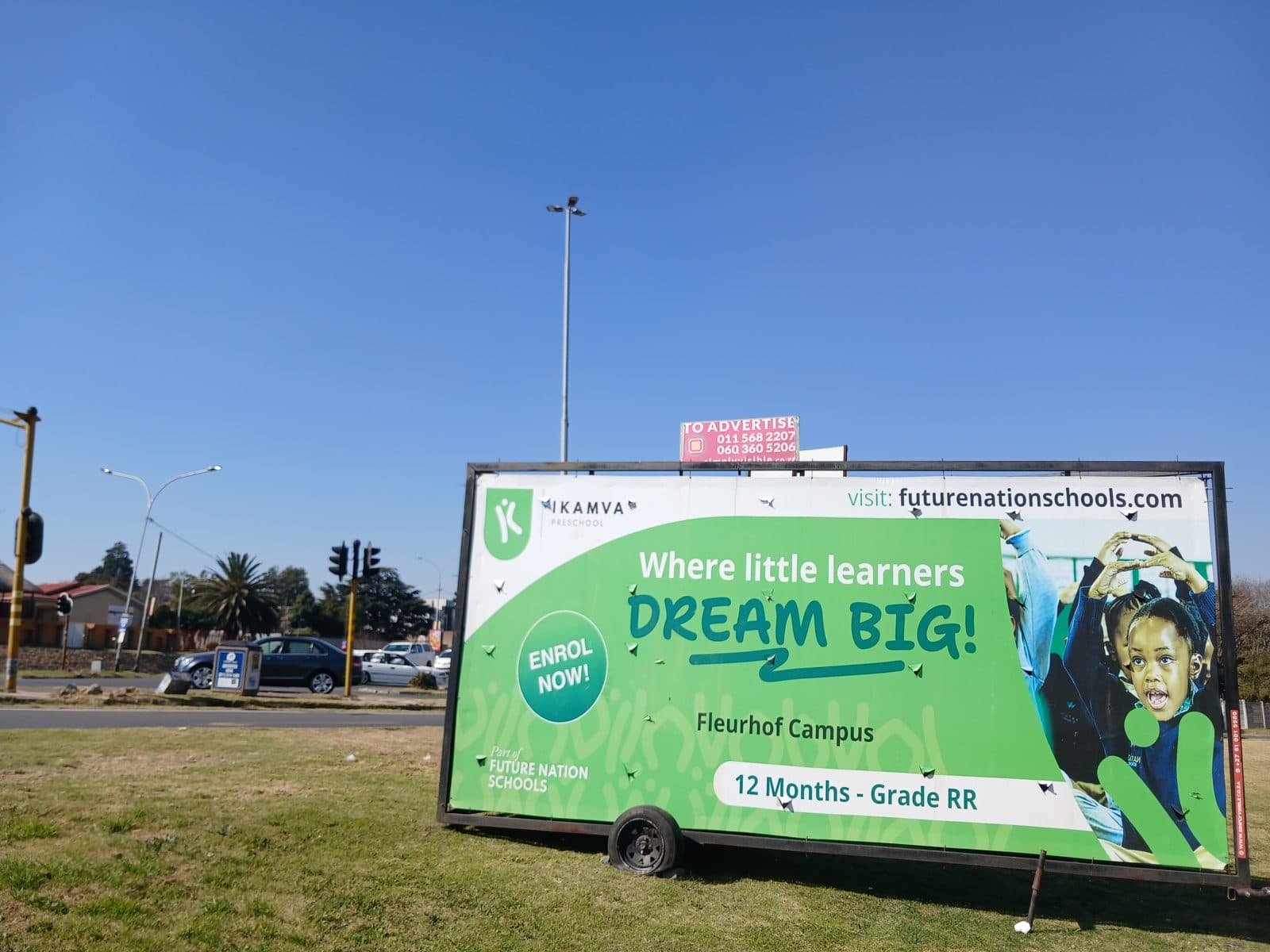 Future Nation Schools preschool enrolment billboard on a Simply Visible trailer at a busy intersection